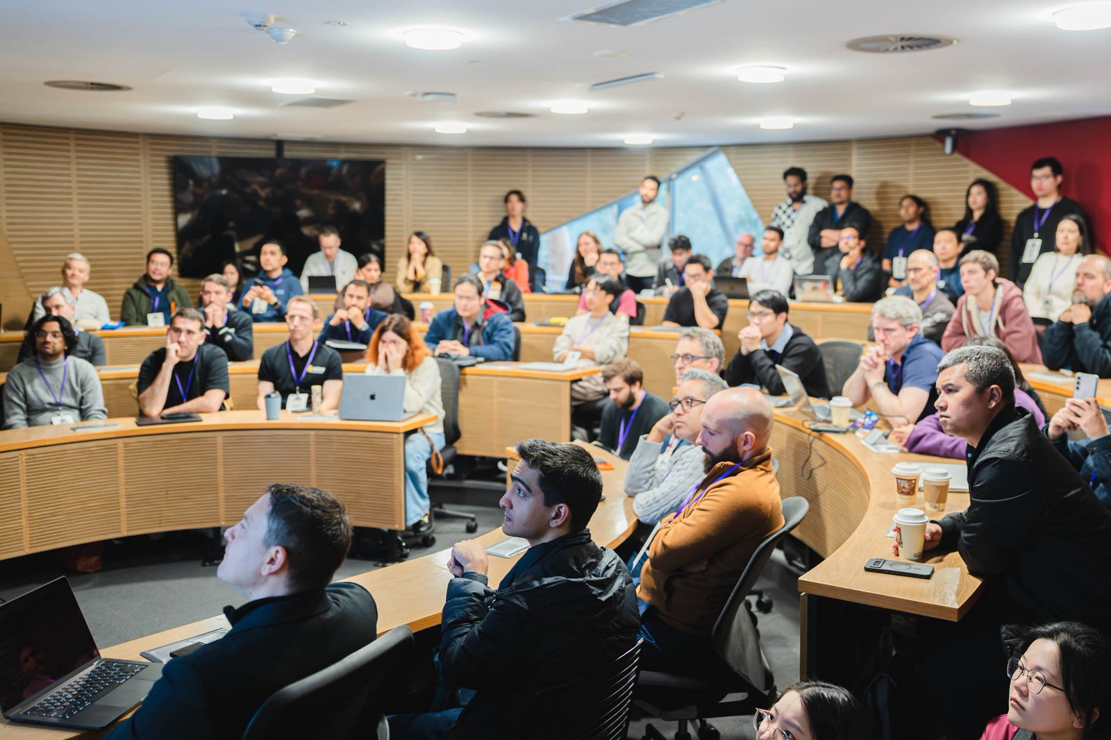A full audience inside a technology conference theatre