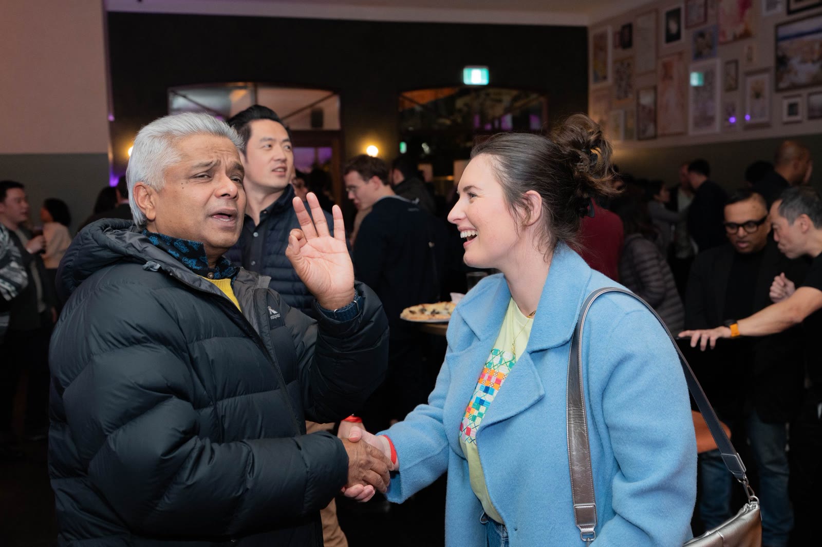 Technology event guests greeting each other during a networking session