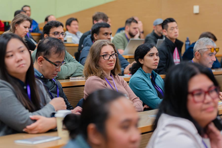 Technology conference attendees listening during a session