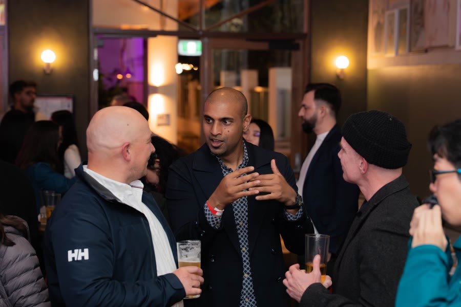 Technology professionals in conversation at an evening event